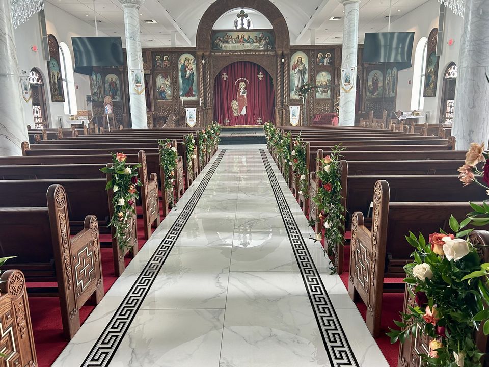 Church aisle with floral pew arrangements